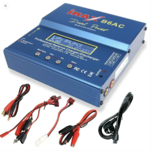 A blue IMAX B6AC balance charger/discharger with various cables. The charger has a built-in AC adapter and screen showing LiPo balance information. Cables include alligator clips, and multi-connectors for various battery types
